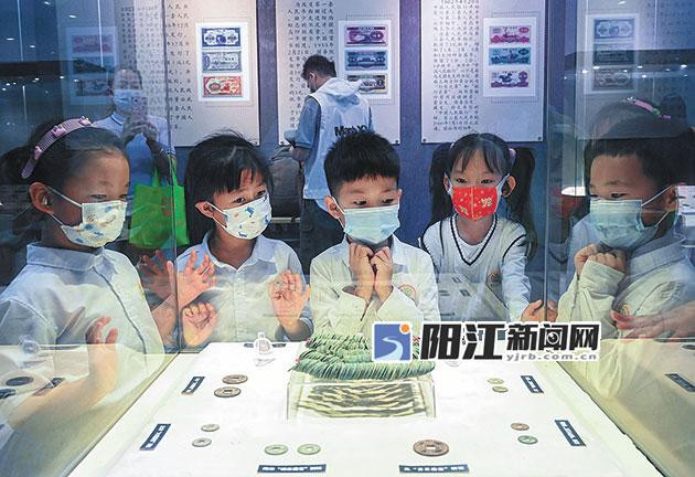 中国钱币历史文化展现场，小观众看得津津有味。.jpg